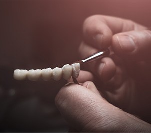 Man painting replacement teeth