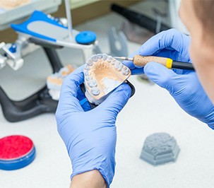 Man carving dentures