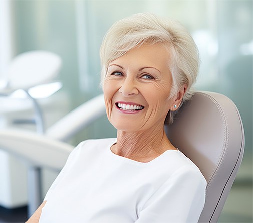 Smiling older woman in dental treatment chair